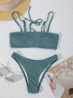 Flat lay of green textured bikini set with straps.