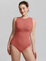 Woman in mineral red crew-neck shaping bodysuit, front view.