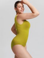 Side view of lawn green seamless bodysuit.