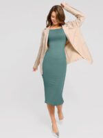 Woman styling the light green shaper dress with a blazer.
