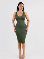 Woman in dark green deep V-neck shaper dress, front view.