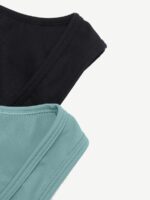 Close-up of black and green athletic fabric with flat seam stitching.