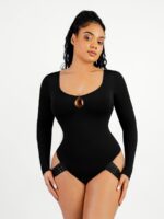 Woman in black long-sleeve scoop neck thong bodysuit with droplet cutout, front view.