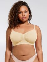 Woman wearing the light skin seamless shaping bra with adjustable straps, holding the strap.