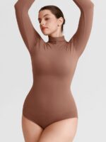 Woman in warm nude buttery bodysuit with arms up.