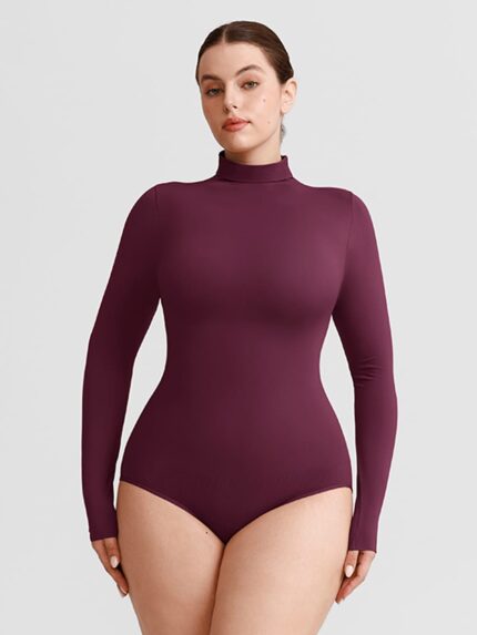 Woman in plum red turtleneck long-sleeve bodysuit.