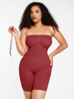 Woman in dark red seamless tummy control shaper, front view.
