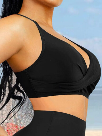 Side view of black swim top with thin adjustable straps.