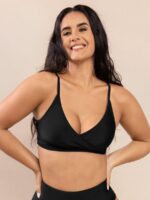 Woman in black two-piece swimsuit set, studio front view.