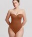Woman wearing the caramel brown underwire strapless thong bodysuit, front view.