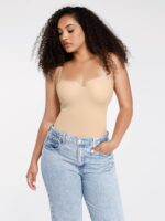 Woman wearing the beige bodysuit as a top with high-waisted jeans.